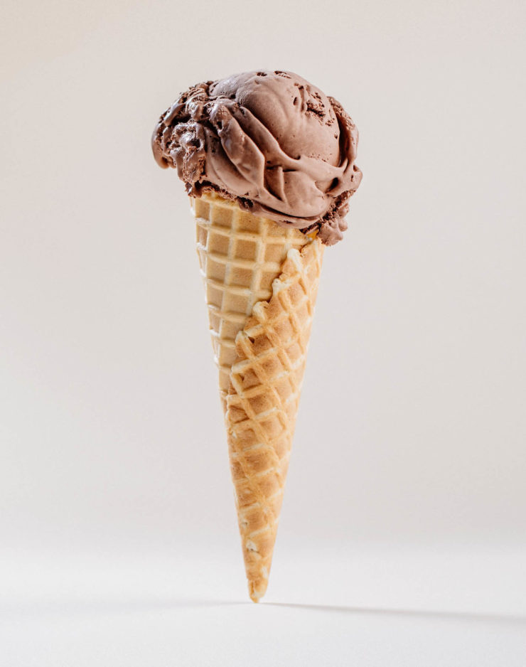 Scoop of chocolate ice cream in a cone, prepared by Earnest Ice Cream of Vancouver.