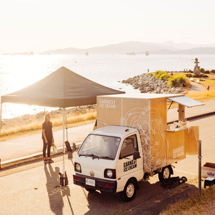 Small Ice Cream food truck at farmers market tent.